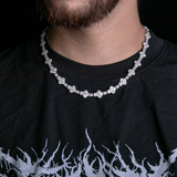 a close up of a man wearing a necklace